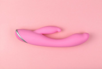 Beautiful evenly lit pink dildo on a glamorous background with copy space.