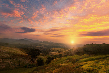 Beautiful sunset or sunrise with colorful sky over the hills