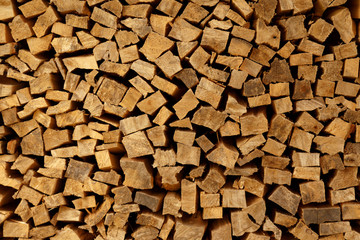 The texture of wooden firewood, randomly split and laid in straight rows