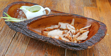 Grilled Pork in wood plate, Thai food style.