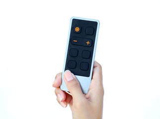Hand holding remote control on white background