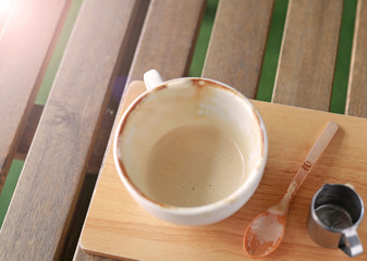 Empty cup of coffee on wooden table.