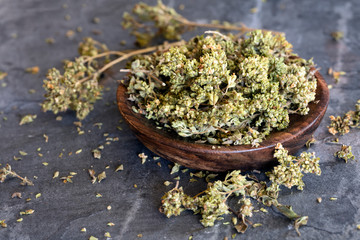 Dried Oregano Sprigs in Bowl over Slate