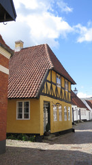 Fototapeta na wymiar Narrow street with old painted houses in Ribe town center, Denmark