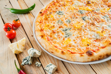 cheese pizza on the wooden background
