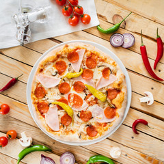 tasty pizza on the wooden background
