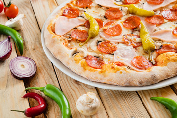 tasty pizza on the wooden background