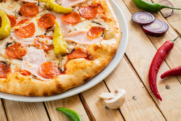 tasty pizza on the wooden background