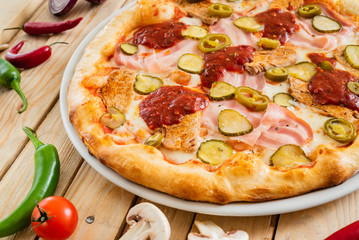 tasty pizza on the wooden background
