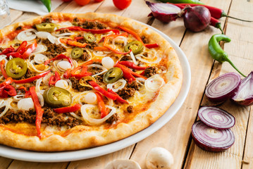 tasty pizza on the wooden background