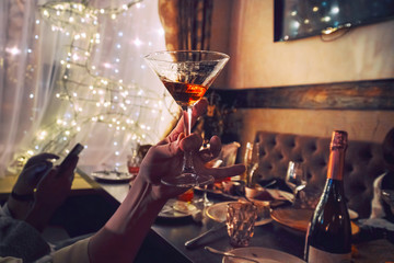 Glass of wine in hand on the background of the table. Selective focus