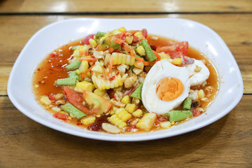 Corn Papaya salad with salted eggs. Thai traditional.
