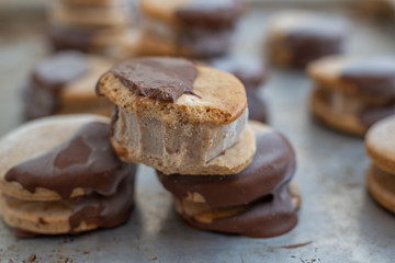 Sweet delicious ice cream cookie sandwiches on table