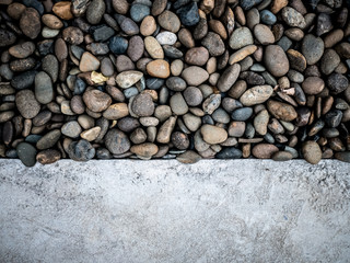 Stone mineral rocks and pebbles dark grey, beige and white color with concrete copy space textured background
