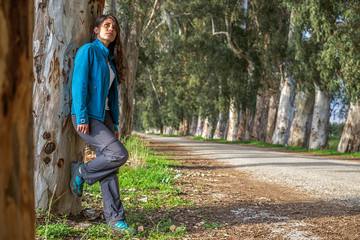 The woman with eucalyptus tree on the road. © feyyazalacam3399
