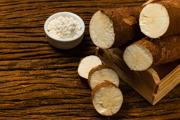 Manihot esculenta. Cassava, yuca, manioc, mandioca, Brazilian arrowroot. Tapioca on wooden background old. Selective focus.
