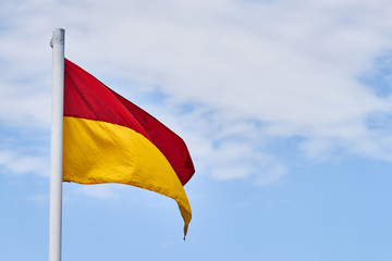 Lifeguard flag and blue sky background