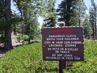 Concrete warning sign at Yovimpa Point, one of the breathtaking scenic points at Bryce Canyon National Park. 