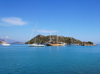 Fototapeta na wymiar Blue lagoon with yachts. Ships stand near the shore against the backdrop of a beautiful landscape.