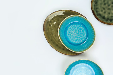 Simple rustic handmade blue crockery  on a white background