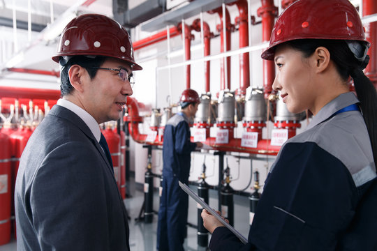 Technical personnel in the factory fire control room inspection