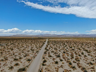 Aerial view of empty dirt road in the arid desert. Off road in the desert. Joshua Tree National Park. American national park in southeastern California, USA.