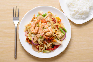 Spicy papaya salad with shrimp and rice noodles, Thai food