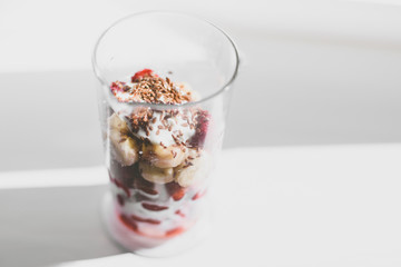 Strawberries smoothie with linseeds and bananas, healthy and useful drink, gray background.