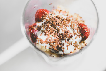 Strawberries smoothie with linseeds and bananas, healthy and useful drink, gray background.