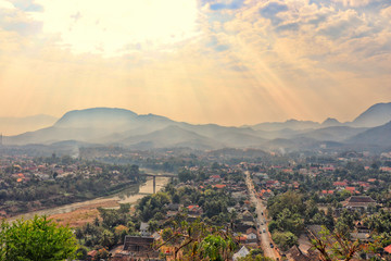 Obraz premium Cityscape of Luang Prabang from the top of Mount Phou Si - views of the city, Nam Khan rivers and the forested mountains - famous and popular touristic sights