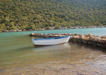 Fototapeta na wymiar Fishing boat stands at the seashore.