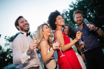 Group of friends at party dancing and smiling together