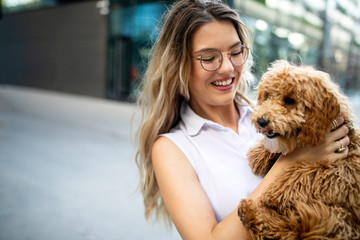 Beauty woman with her dog playing outdoors