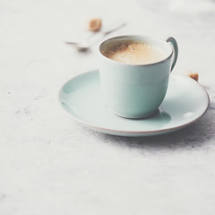A cup of coffee on light grey background