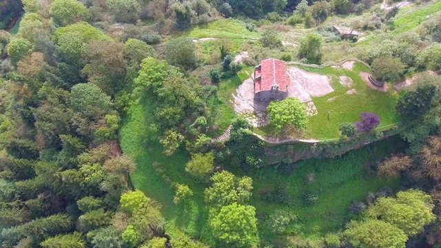 Aerial view of a Chapel located in the middle of the village of Rupit, on a rocky hill surrounded by the stream. Catalonia, Spain