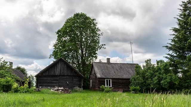 Timelapse of old building in a small village, countryside. Summer time.