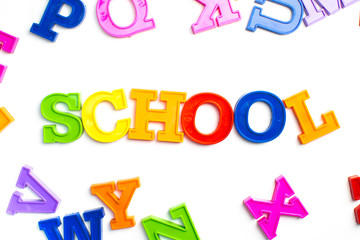 Heap of plastic colored alphabet letters close up. School
