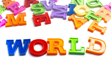 Fototapeta premium Heap of plastic colored alphabet letters close up. World