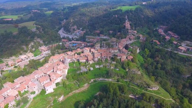 View from above to Rupit ancient village. Old houses, farms and building are on the hill top of a small mountain. Barcelona province, Spain.