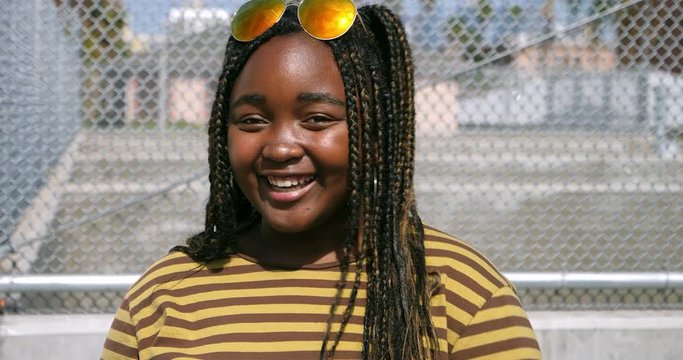 Young black African American girl emotionallyl talking to friends in Los Angeles, California, 4K 