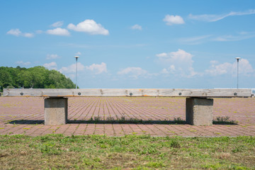 Wooden bench in the square. Deserted square in summer.