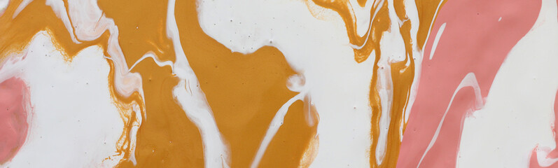 photography of abstract marbleized effect background. gold, yellow, orange and white creative colors. Beautiful paint