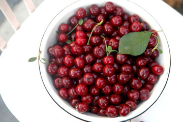 Fresh cherry in the rustic metal bowl 