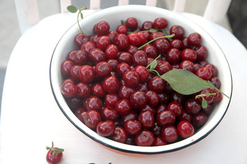 Fresh cherry in the rustic metal bowl 