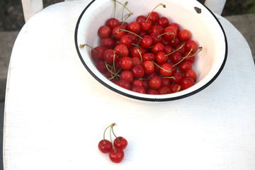 Fresh sweet  cherry in the rustic metal bowl
