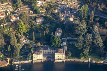 The coast of Lake Como at golden hour. The view from the window of a light aircraft. Como, Italy.