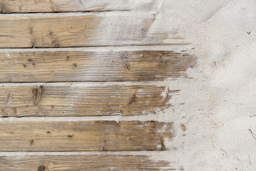 Weathered Wooden Boardwalk on Sand / Aged beach brown wooden floor over summer sand - obrazy, fototapety, plakaty