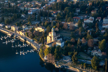 Fototapeta na wymiar Church of San Lorenzo, flying over Lake Como. Tremezzo, Italy.