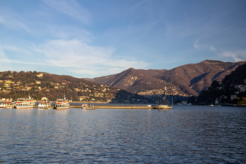 Lake Como at sunrise. Mountain View. In the foreground, you can see the sculpture Life Electric. Como, Italy.