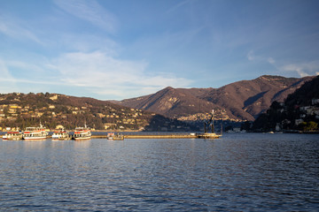 Lake Como at sunrise. Mountain View. In the foreground, you can see the sculpture Life Electric. Como, Italy.